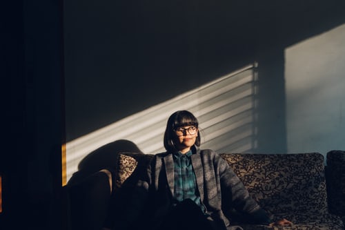 a woman sitting near the window